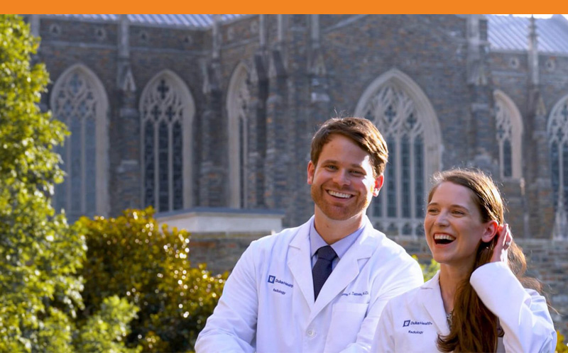 Photo of two doctors smiling outside of Duke School of Medicine