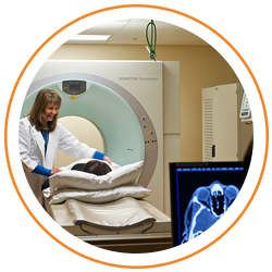 Photo of radiolgist talking to patient in MRI room