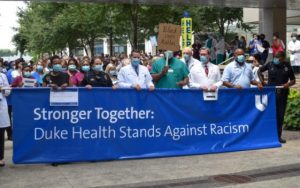 Duke doctors holding Stronger Together: Duke Health Stands Against Racism banner