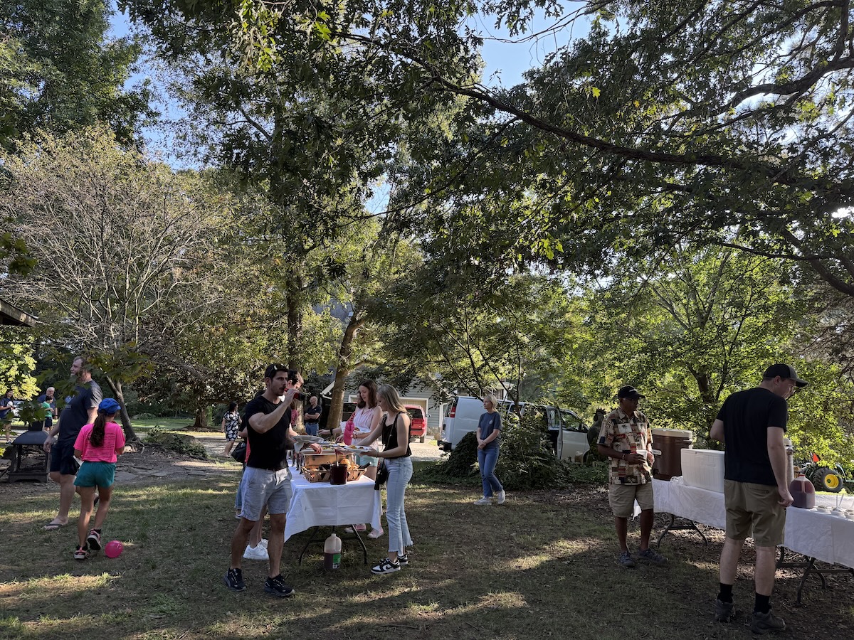 People at picnic table getting food
