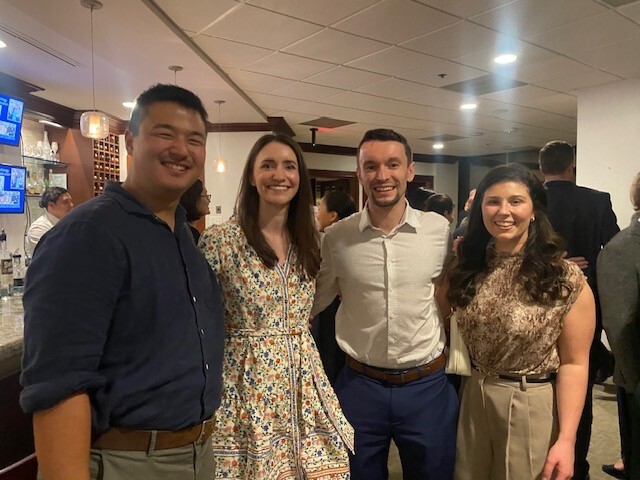 Four people smiling