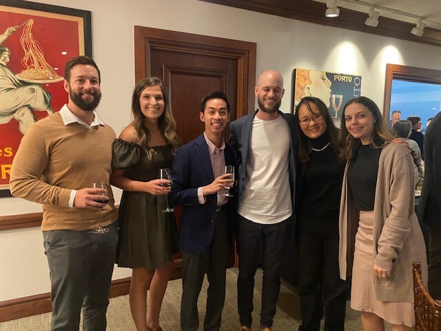 Group of people standing in front of art
