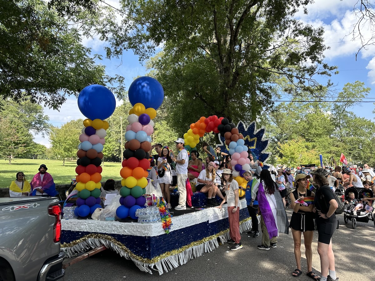 People at pride parade with float