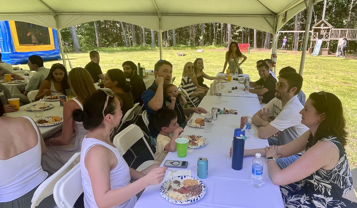 People outside at a long table