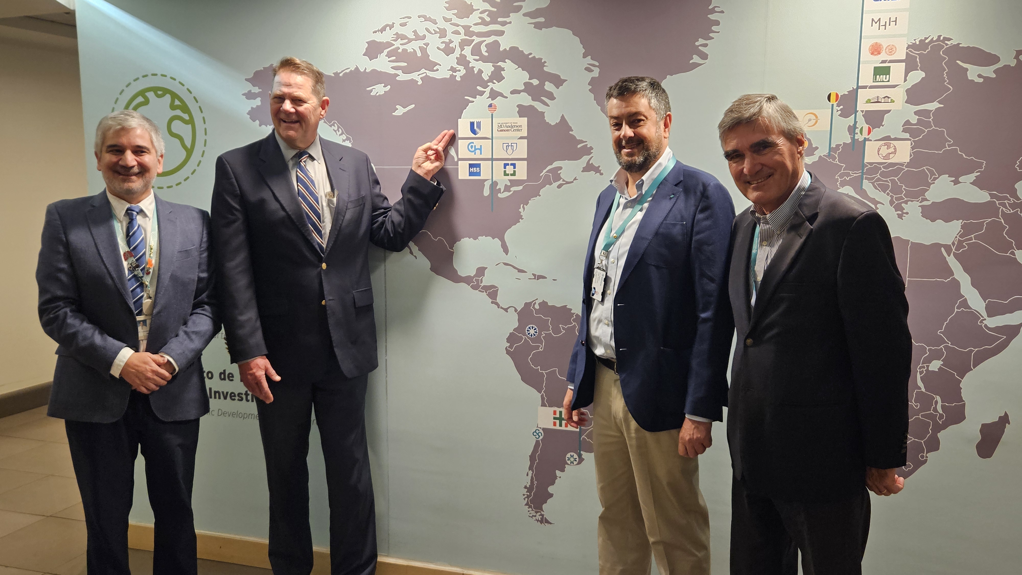 Dr. Paulson and colleagues stand in front of a map