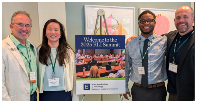 People standing next to a poster for RLI Summit