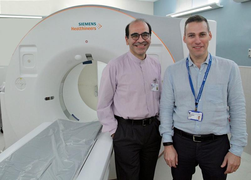 Ehsan Samei and Daniele Marin in front of the photon counting CT machine