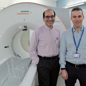 Ehsan Samei and Daniele Marin in front of the photon counting CT machine