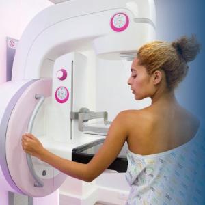 Woman getting a mammogram with text overlay